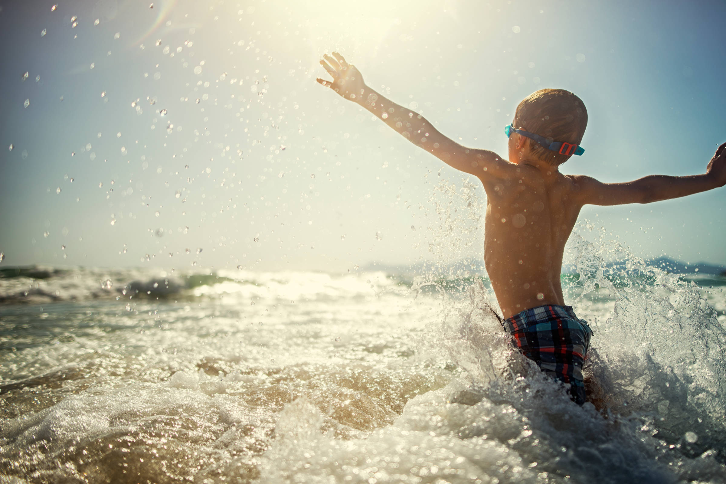 Boy splashing in waves. Photo: Imgorthand.