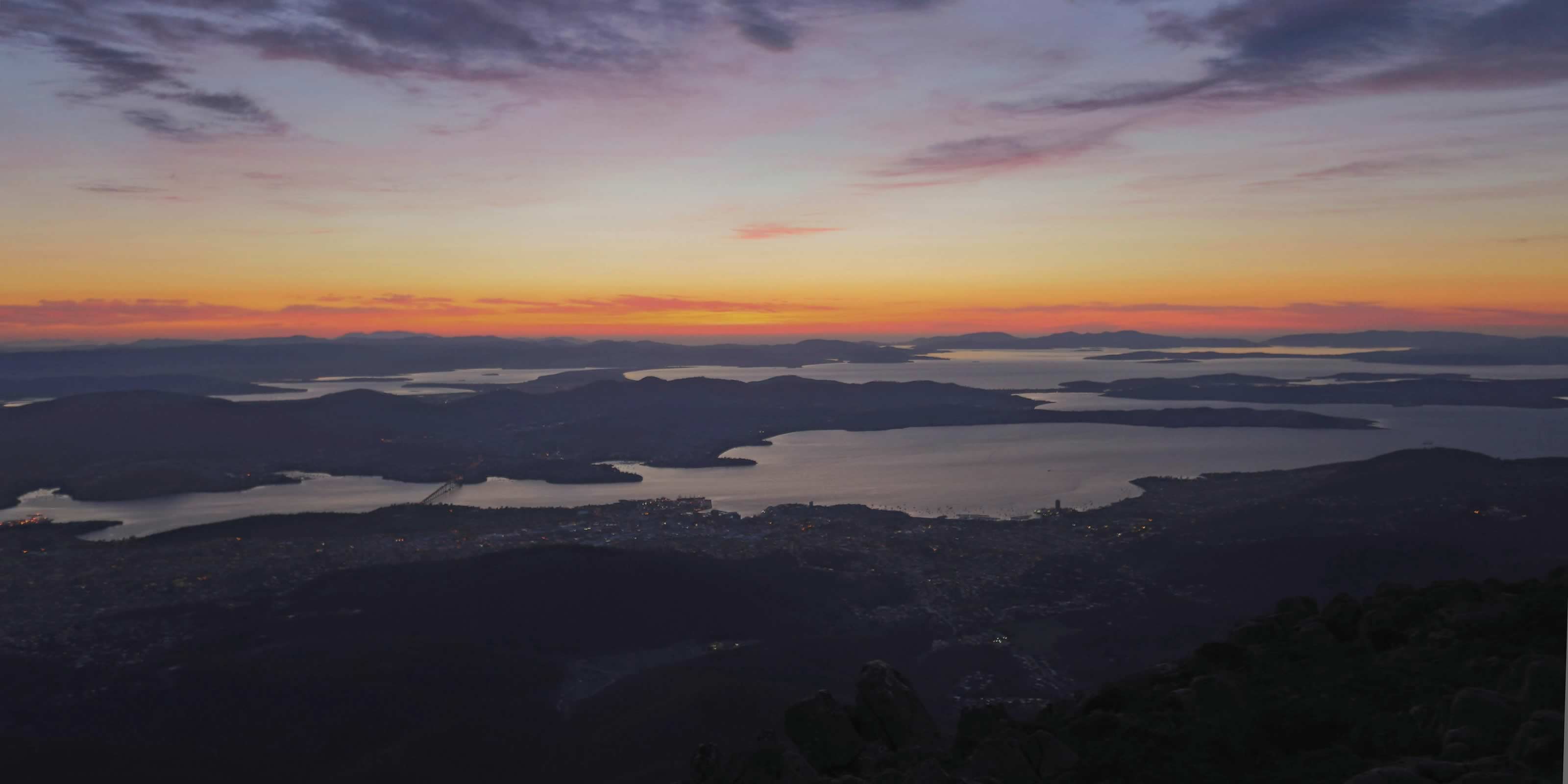 Dawning of a new day over Hobart city from kunanyi / Mount Wellington. Photo: Tourism Australia / Graham Freeman.